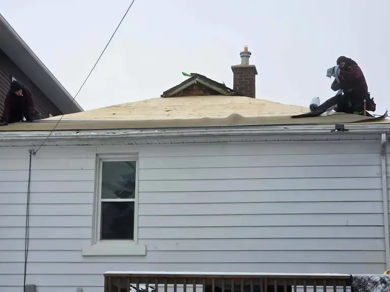 New seamless eavestrough installed along a roof edge